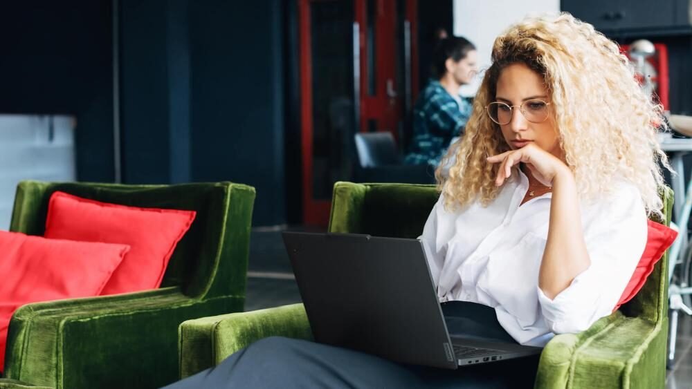 Business professional using a Lenovo ThinkPad business notebook for productivity tasks