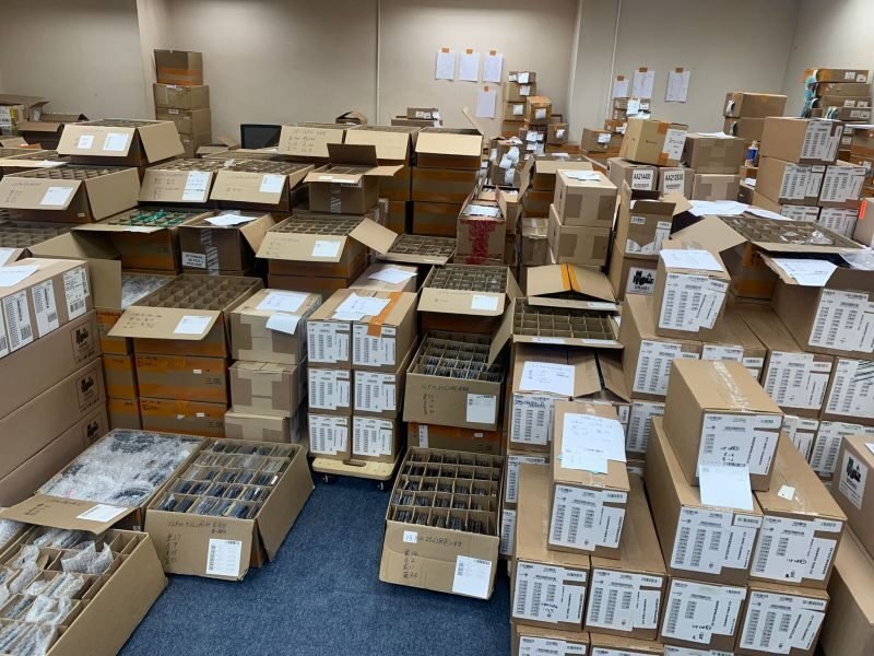 Rows of boxed apple iphone 15 pro units in a distribution center